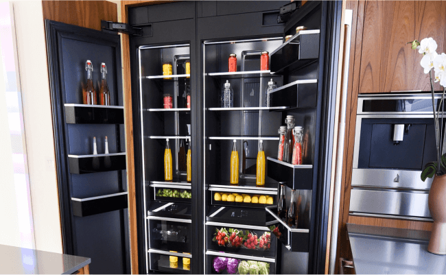 A JennAir Column Refrigerator in a bright kitchen with modern wood cabinetry. 